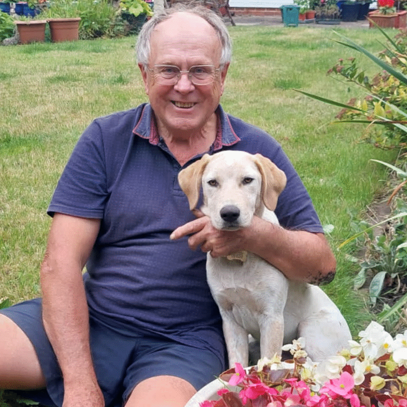 A customer of Koopa's Choice Pet Supplies relaxing in their garden with their dog